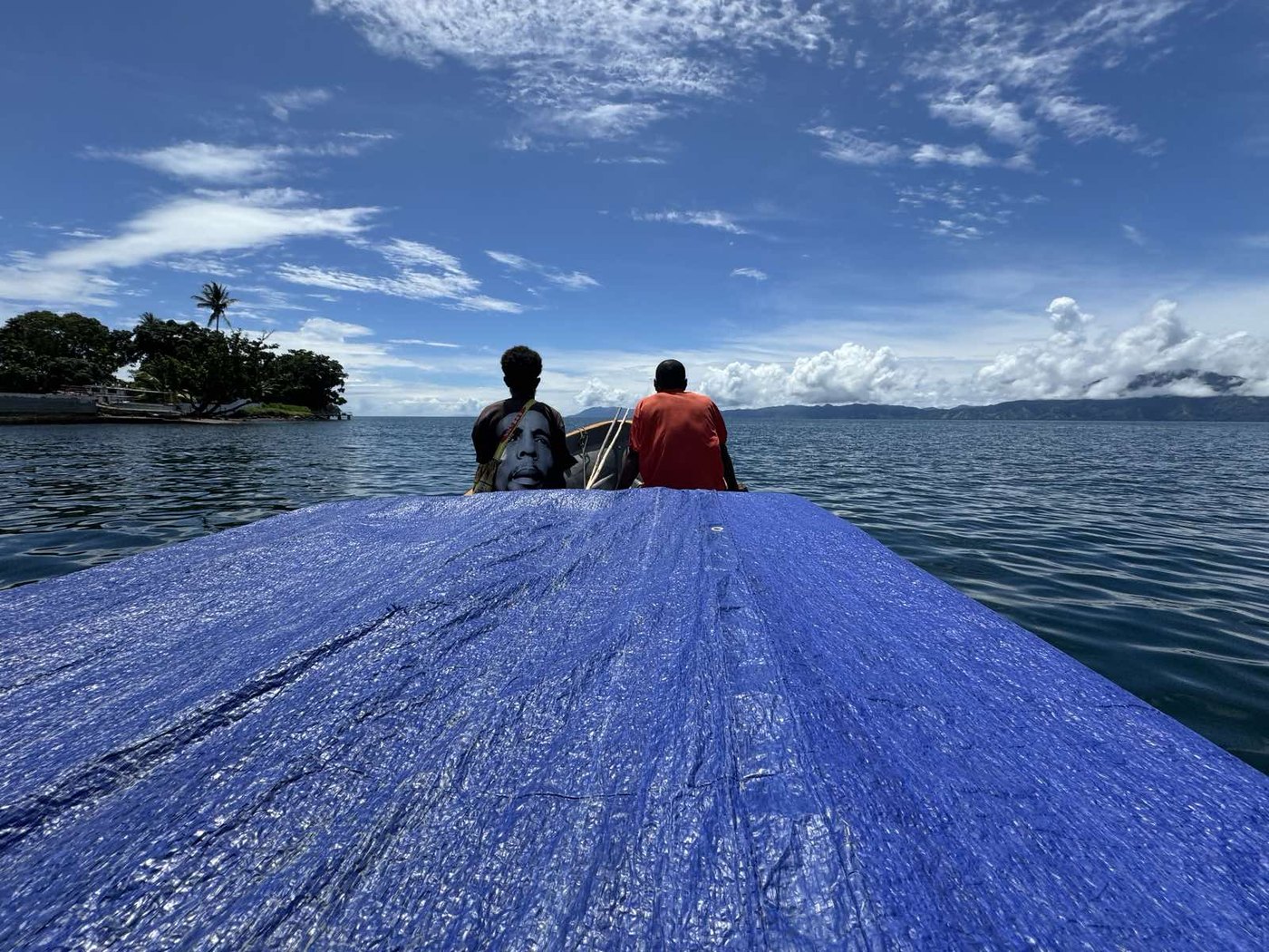 Travel by boat across the waters of Milne Bay Province